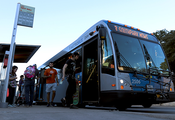 People board a bus at the UT West Mall Station