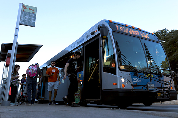 People board a bus at the UT West Mall Station