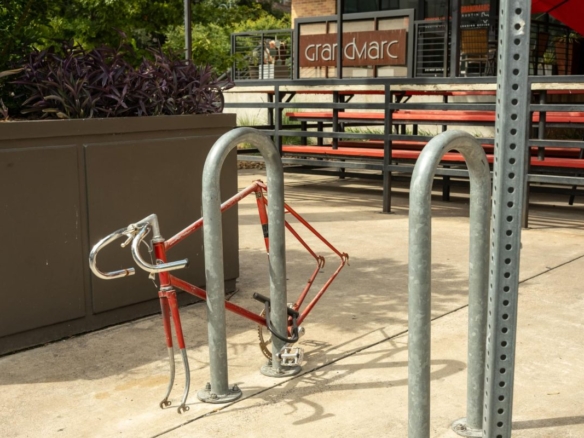 Bike frame with wheels missing attached bike rack