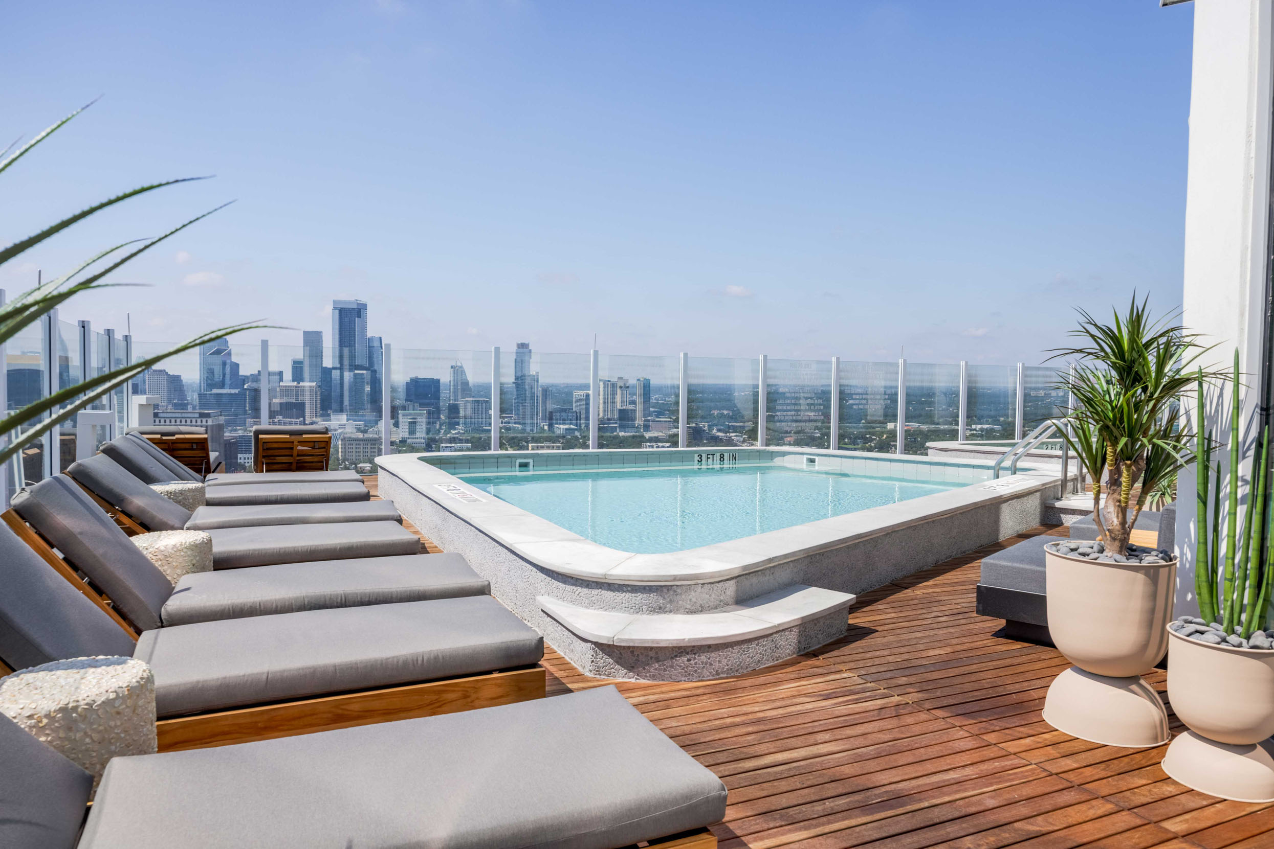 Pool deck with chairs and downtown Austin view