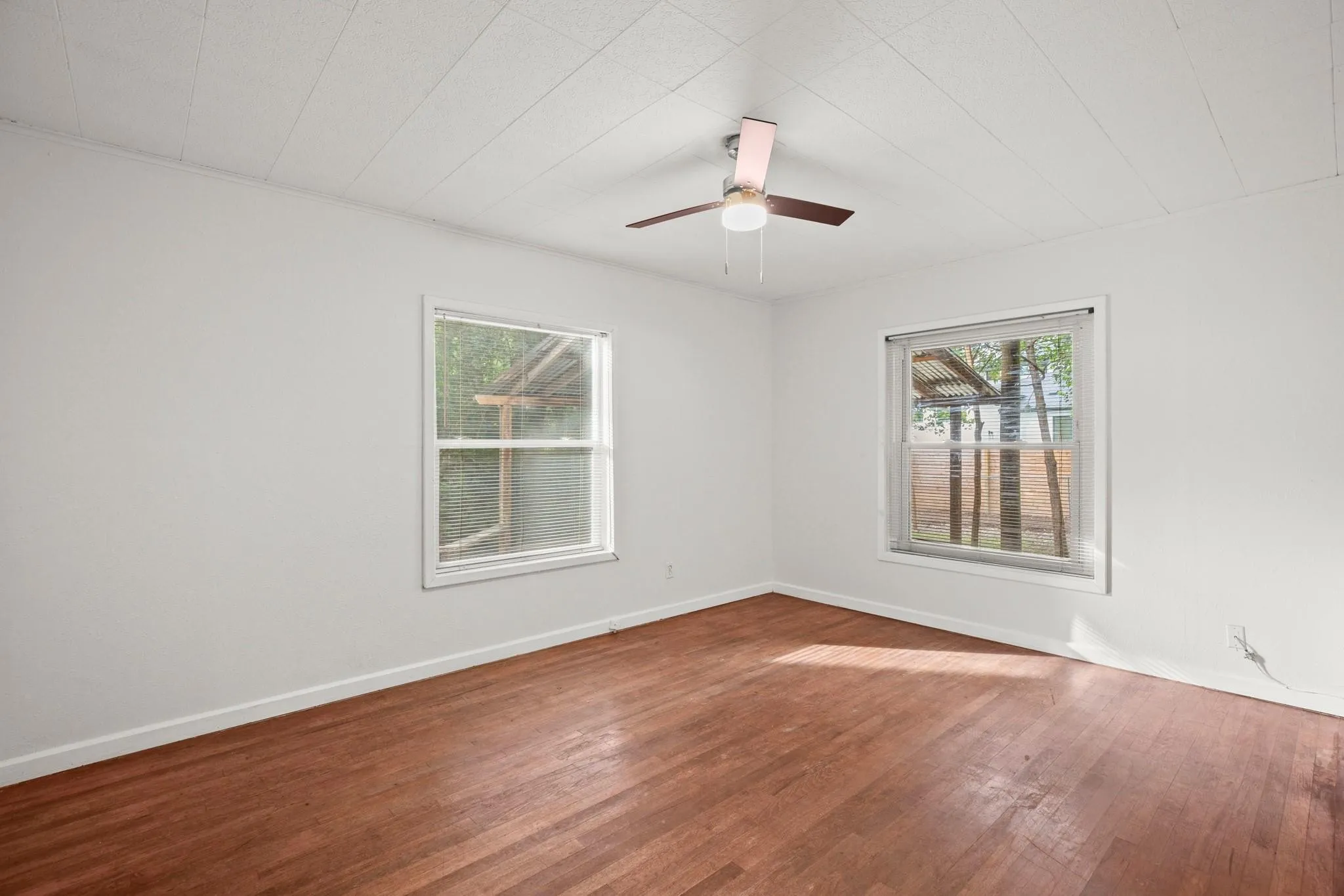 Bedroom with hardwood / wood-style flooring and ceiling fan
